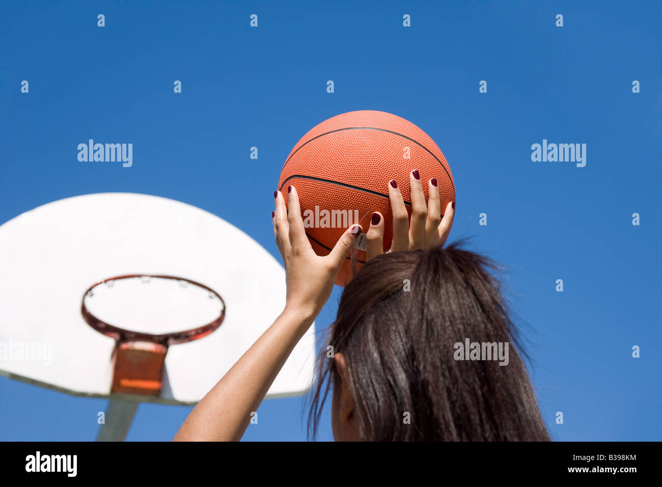A young woman throwing a basketball Stock Photo Alamy