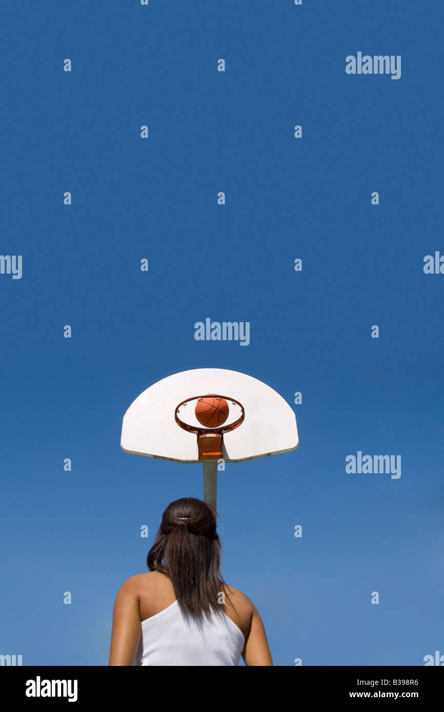 A young woman throwing a basketball Stock Photo Alamy