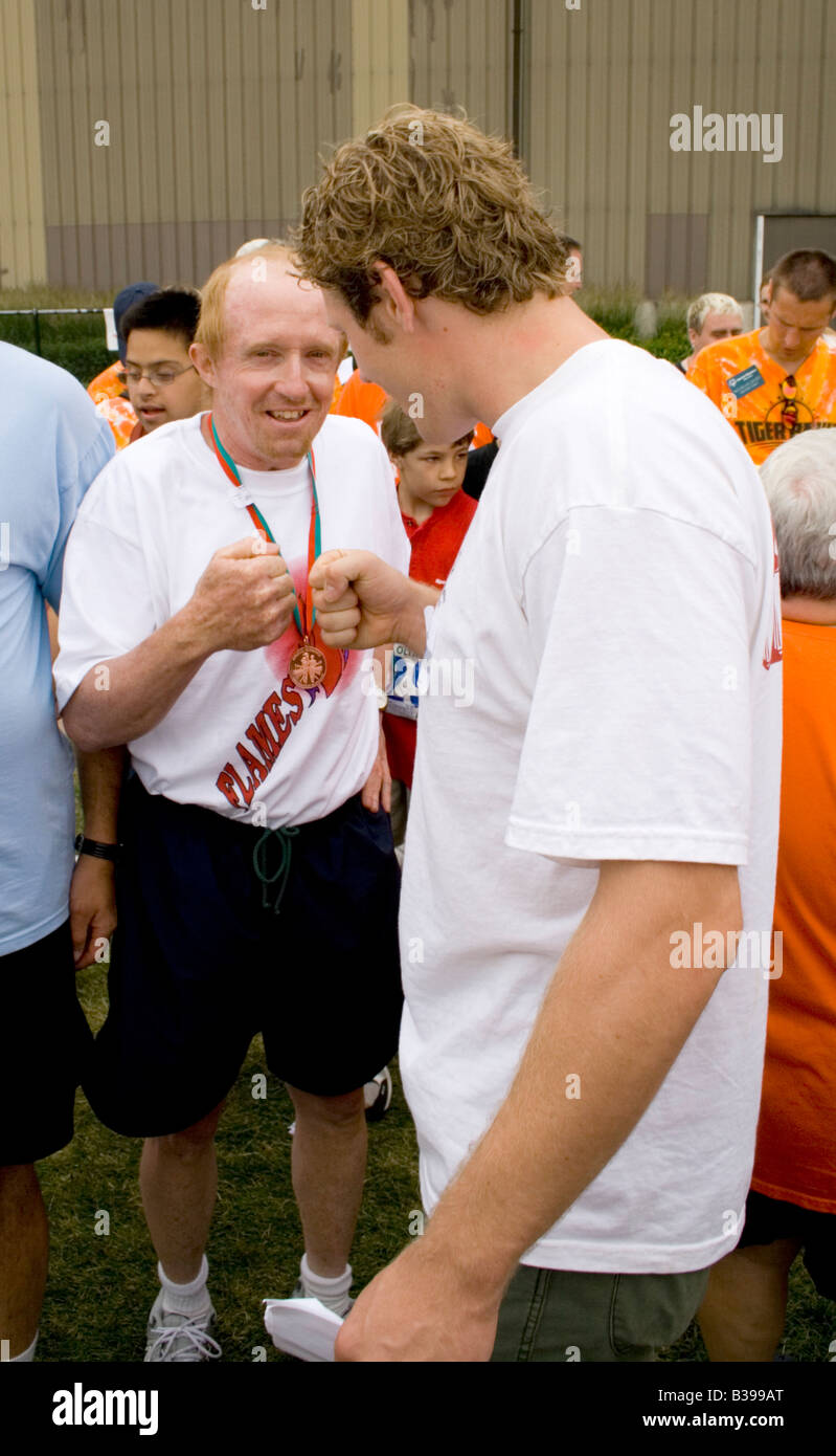 Knuckle handshake at award ceremony. Special Olympics U of M Bierman Athletic Complex