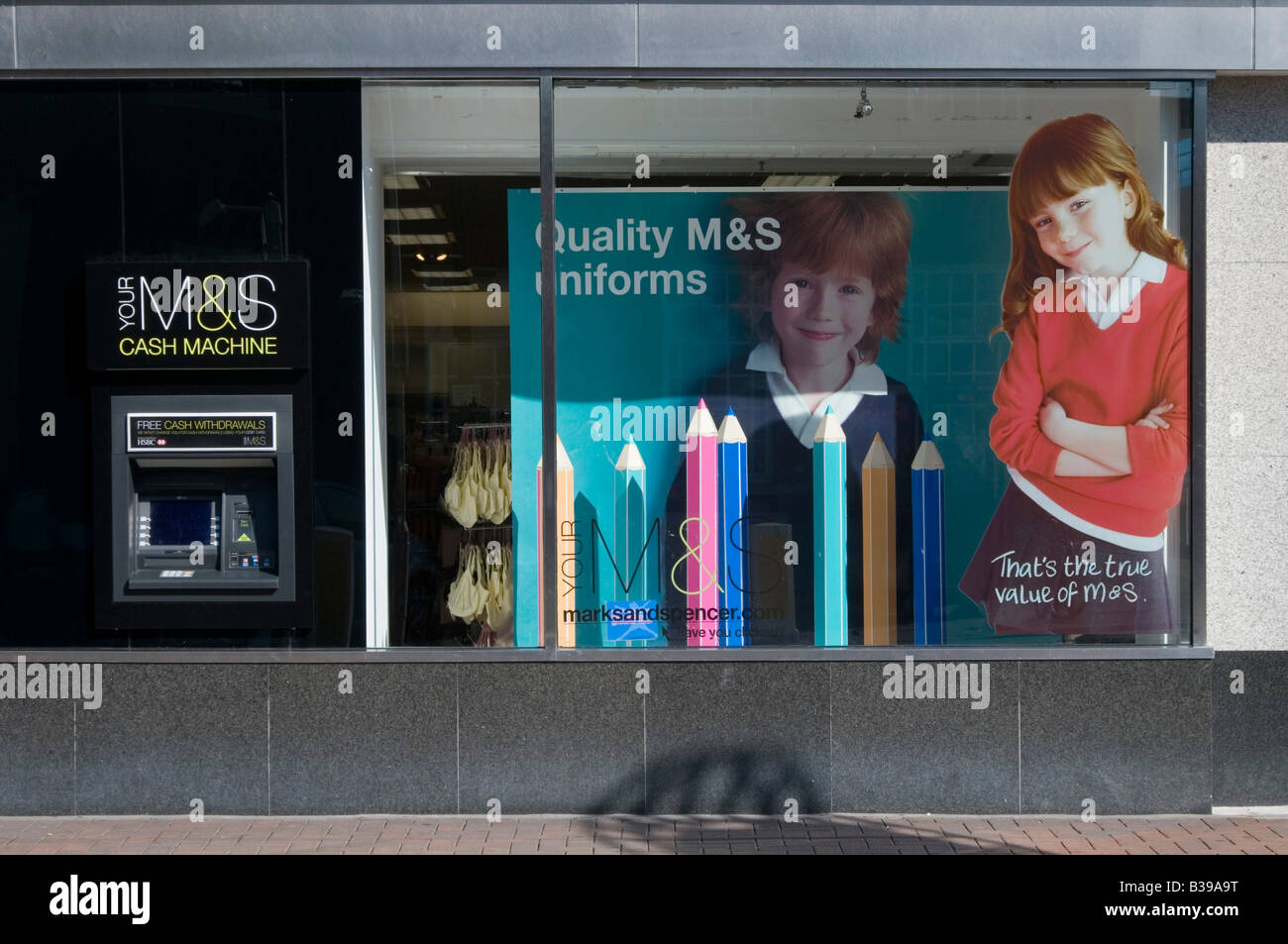 Marks and spencer money ATM cash machine alongside store window back to