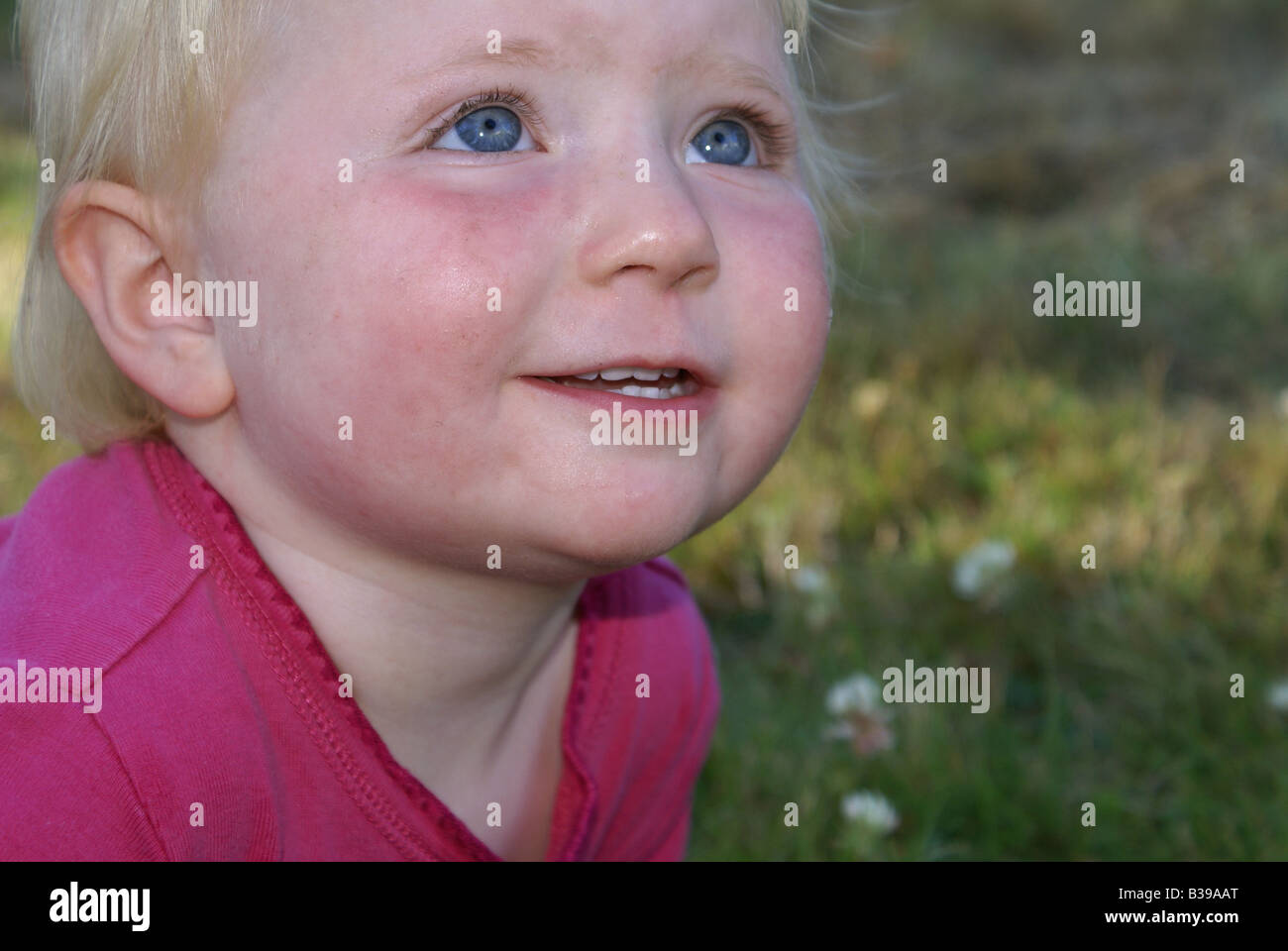 Child girl female looking up horizontal format pink skin smile hi-res ...