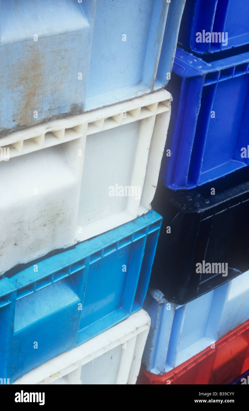 Detail of two stacks of brightly coloured plastic crates used for fish or fruit or vegetables Stock Photo