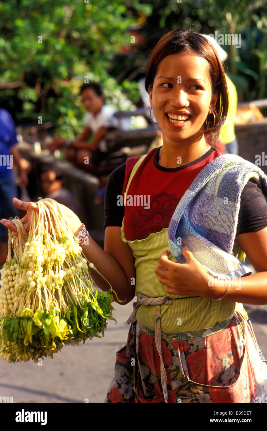 girl selling fragrant flowers outside tondo church manila philippines