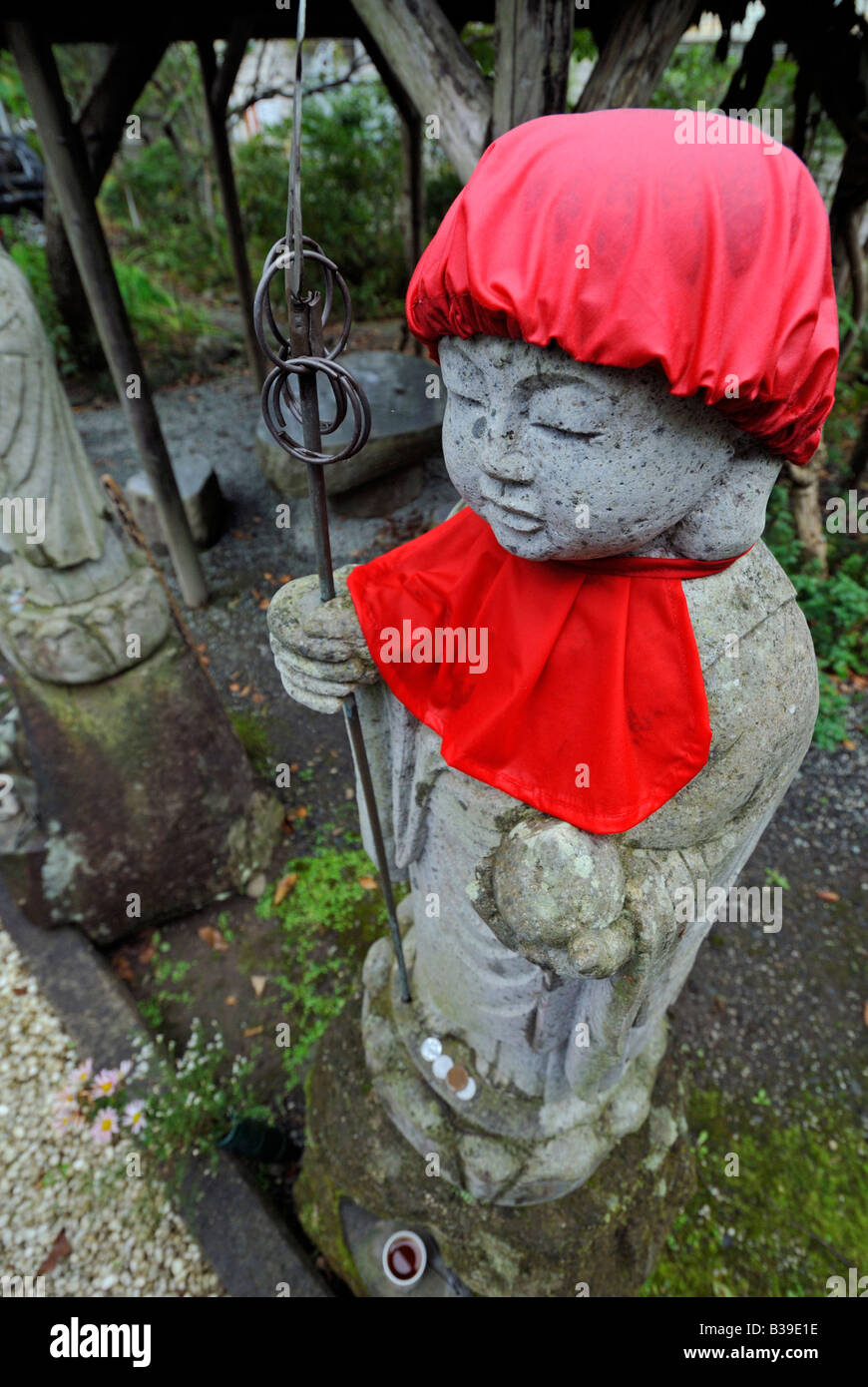 Jizo Bodhisattva statue with red bib and hat symbol of unborn child Tenri in temple Matsushima