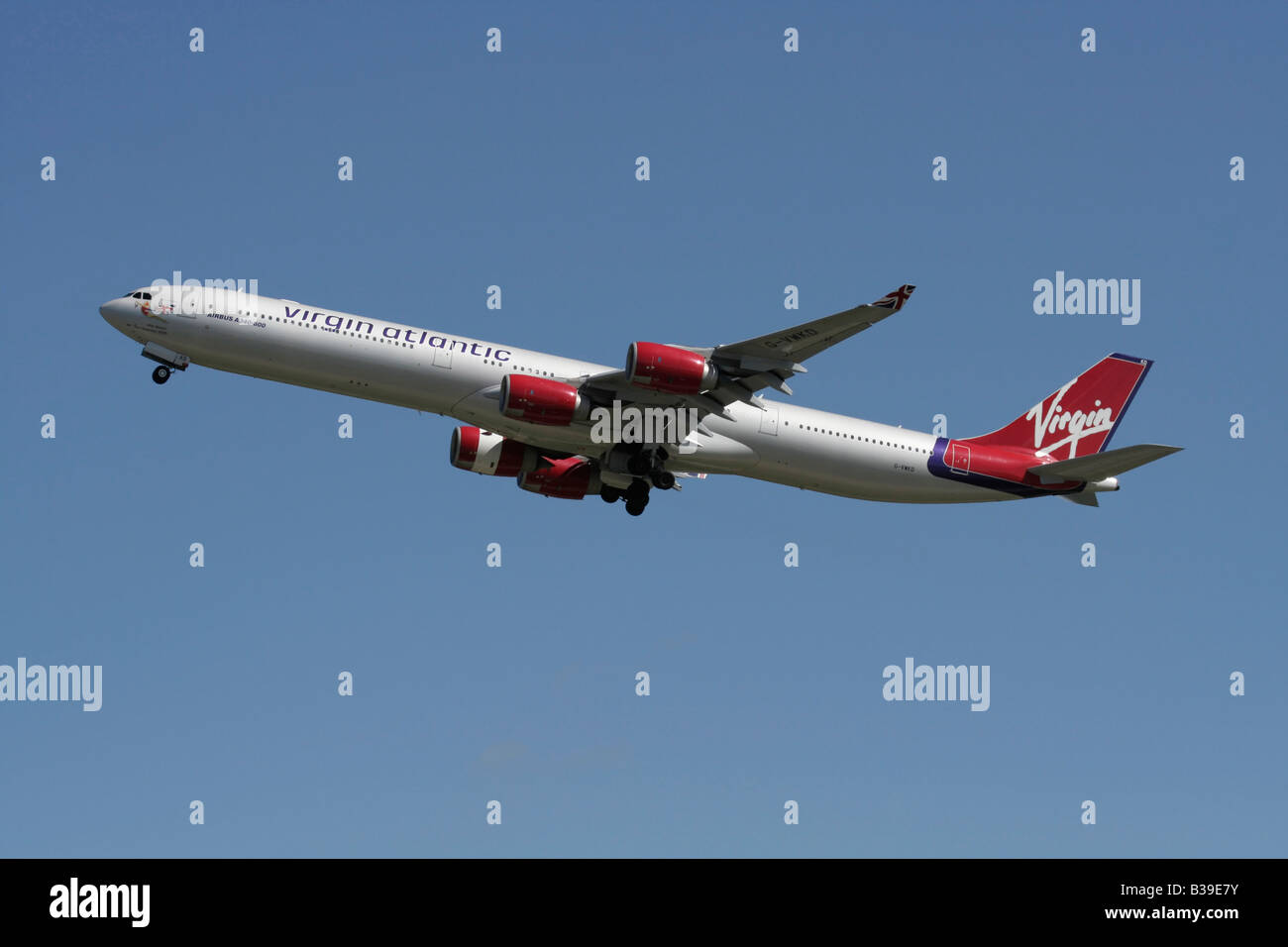 Virgin Atlantic Airways Airbus A340-600 long haul passenger aeroplane flying on departure against a blue sky. Side view. Stock Photo