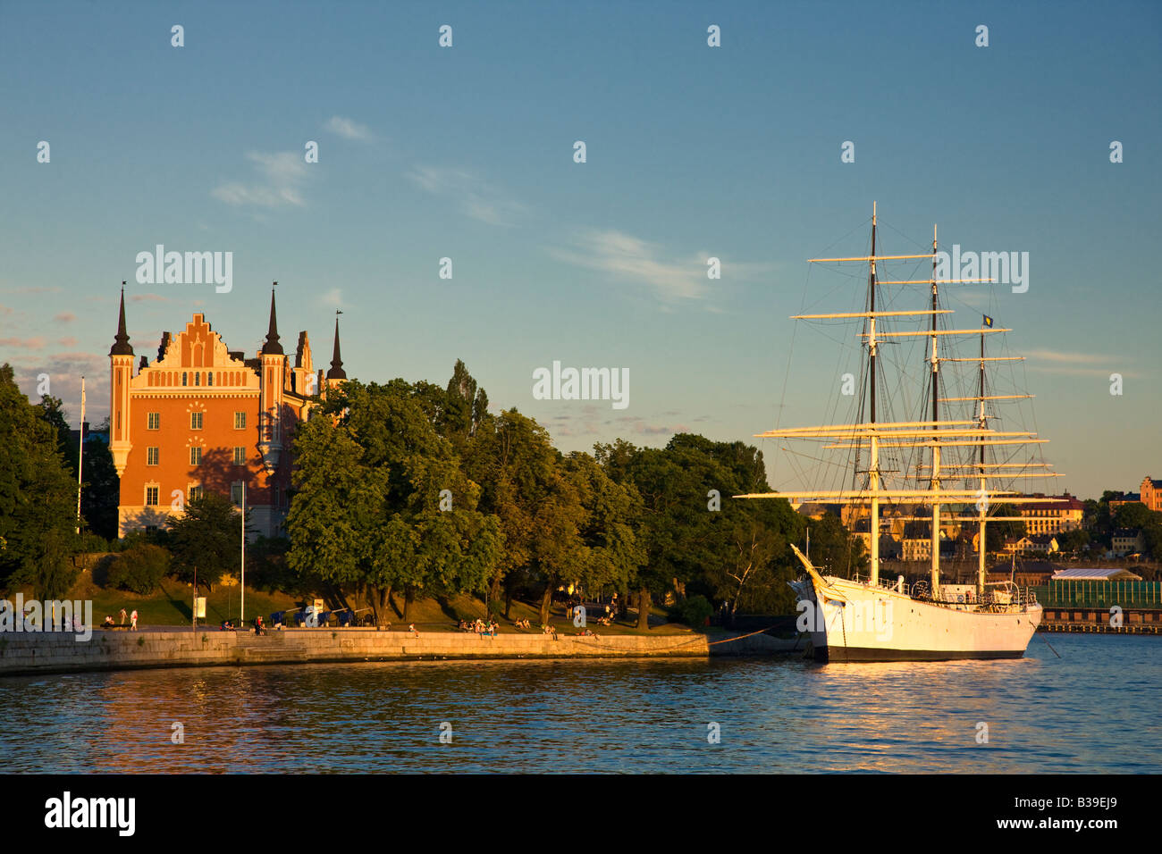Tall sailing ship moored along the seawall on the Stockholm waterfront just before sunset on a summer afternoon. Stock Photo