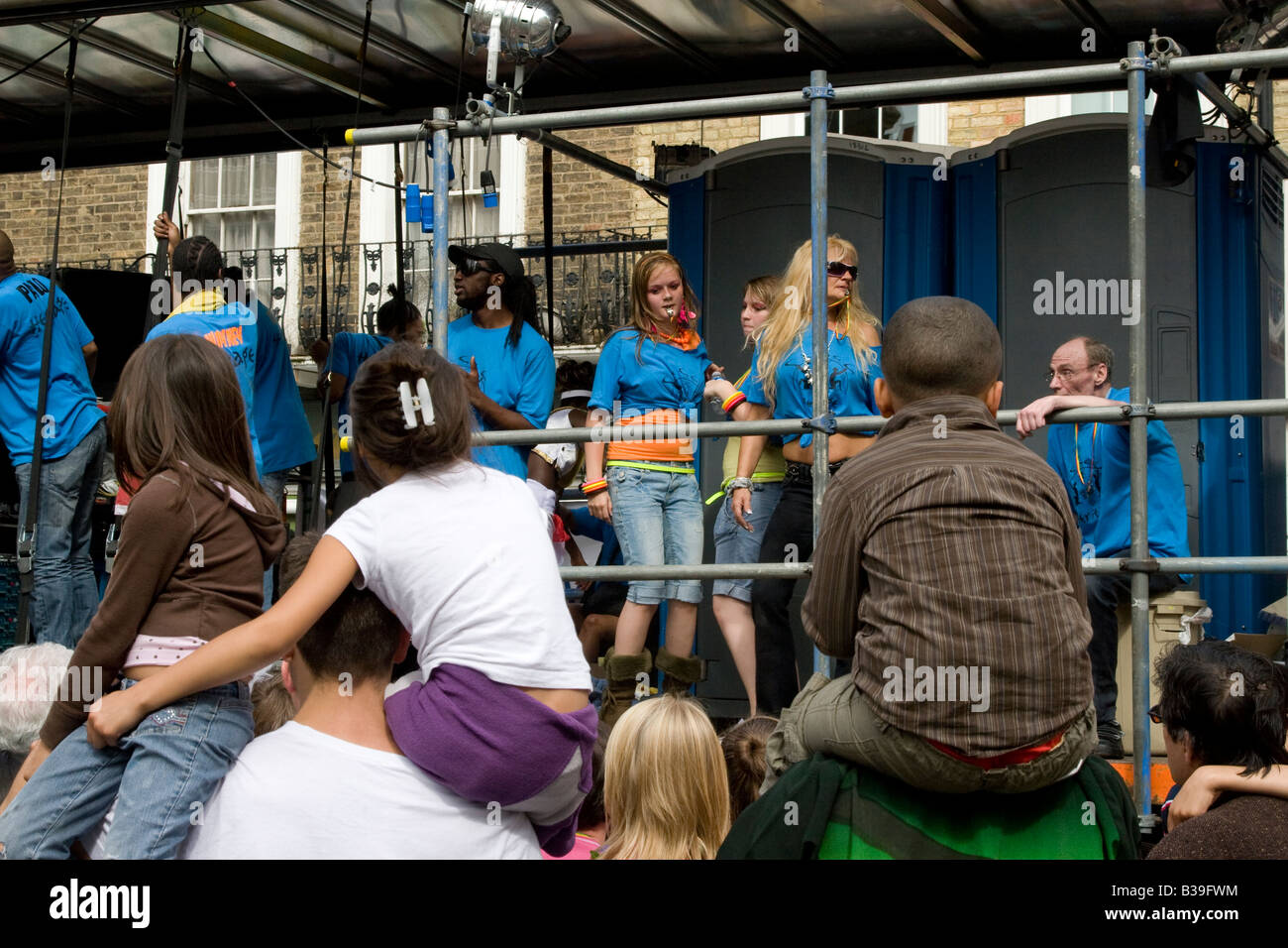 children on shoulders watching float Notting Hill Carnival London UK