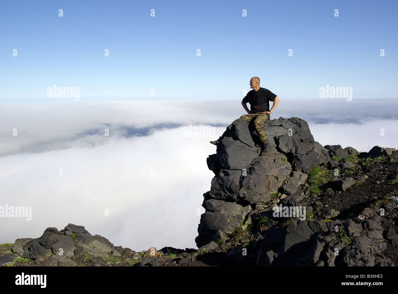 Men climb on top of volcano Tya Tya, Kunashir island, Kuril islands Far East of Russia Stock Photo