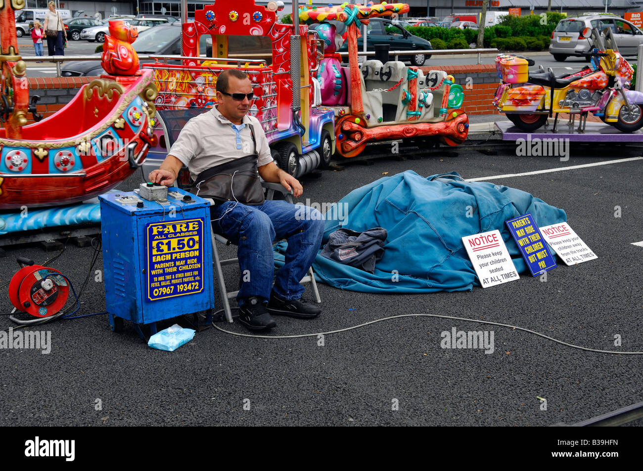 controller man male fairground ride job employment seated sit summer ...