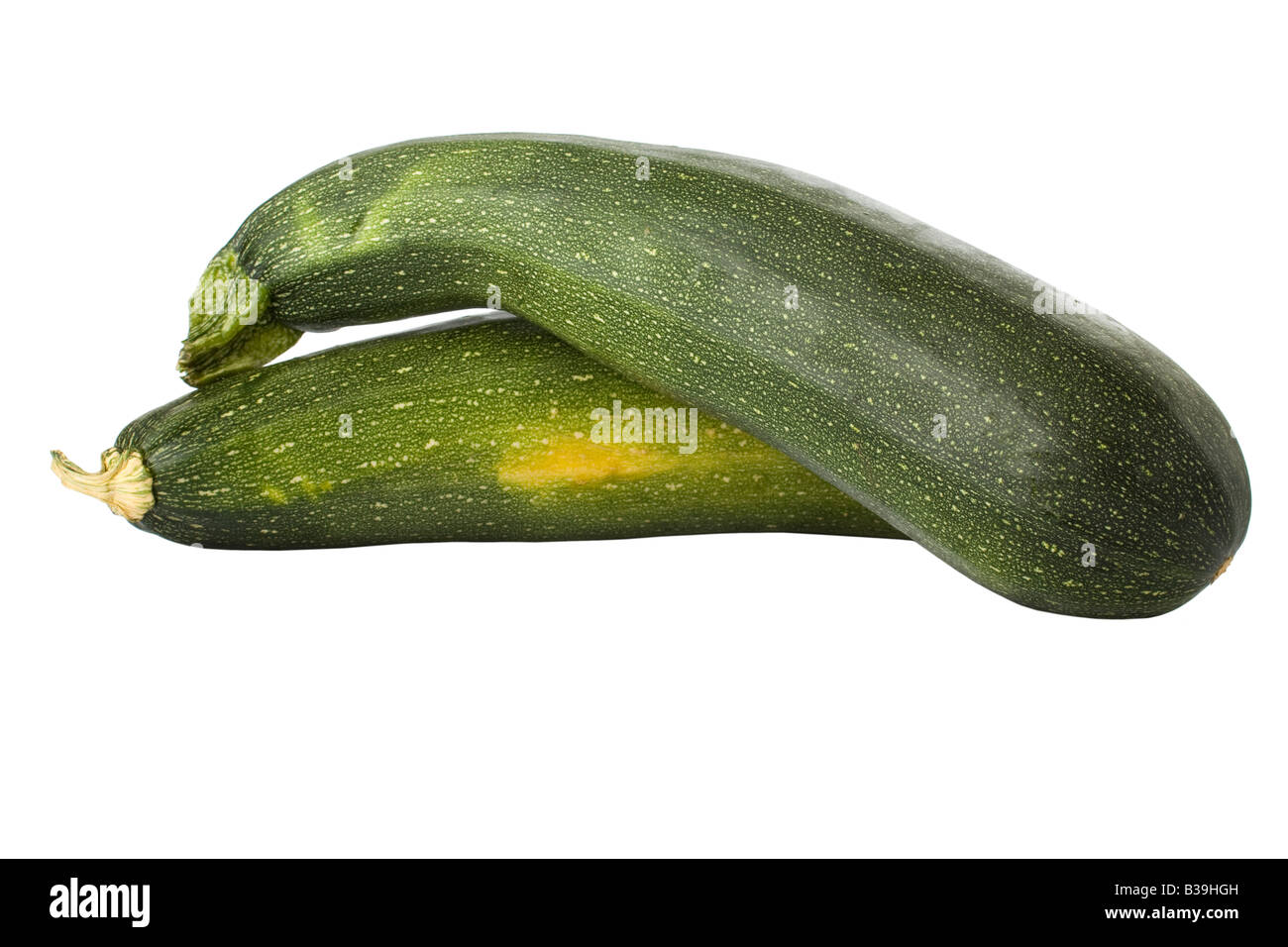 Ripe zucchinis or courgettes isolated on a white background Stock Photo