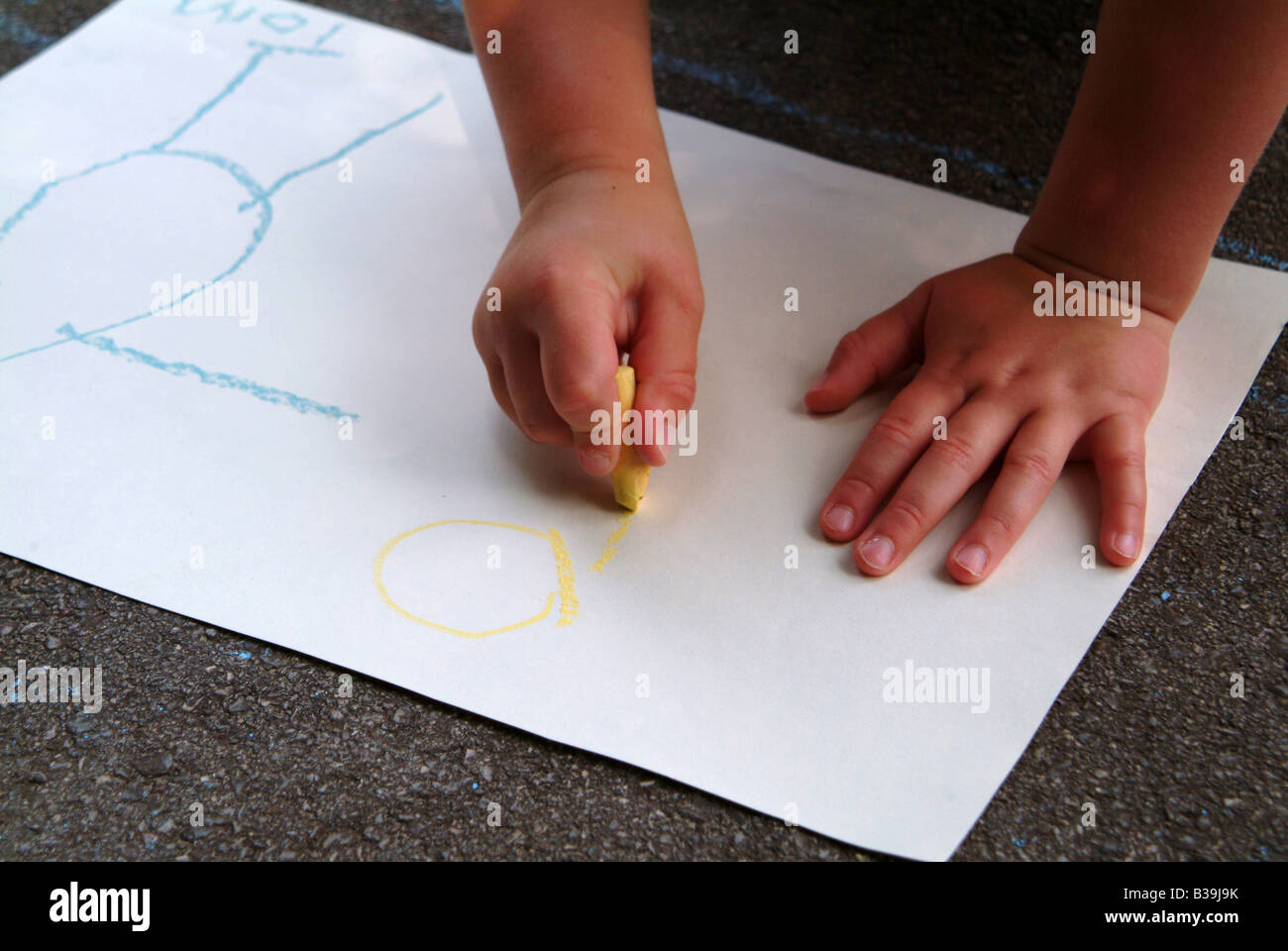 Close-up of a child drawing with crayons on paper Stock Photo - Alamy