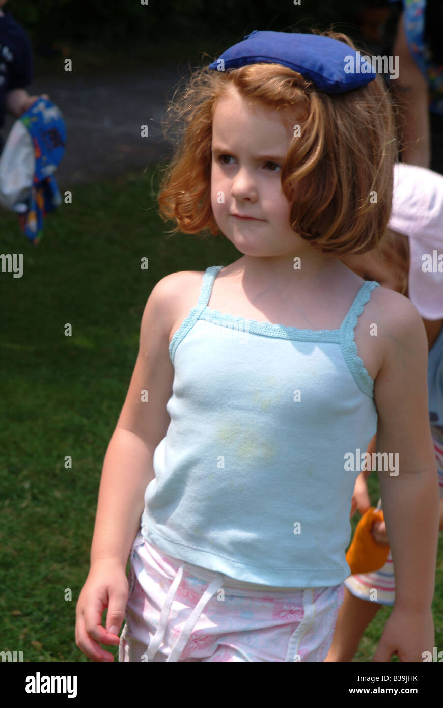 Little girl with a bean bag on her head Stock Photo Alamy