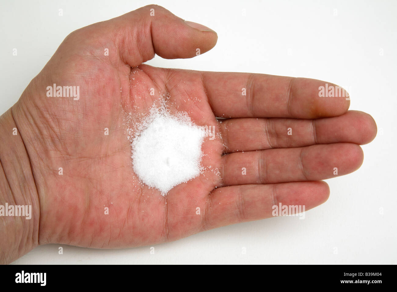 Exactly 6gm of salt on a mans hand Stock Photo - Alamy