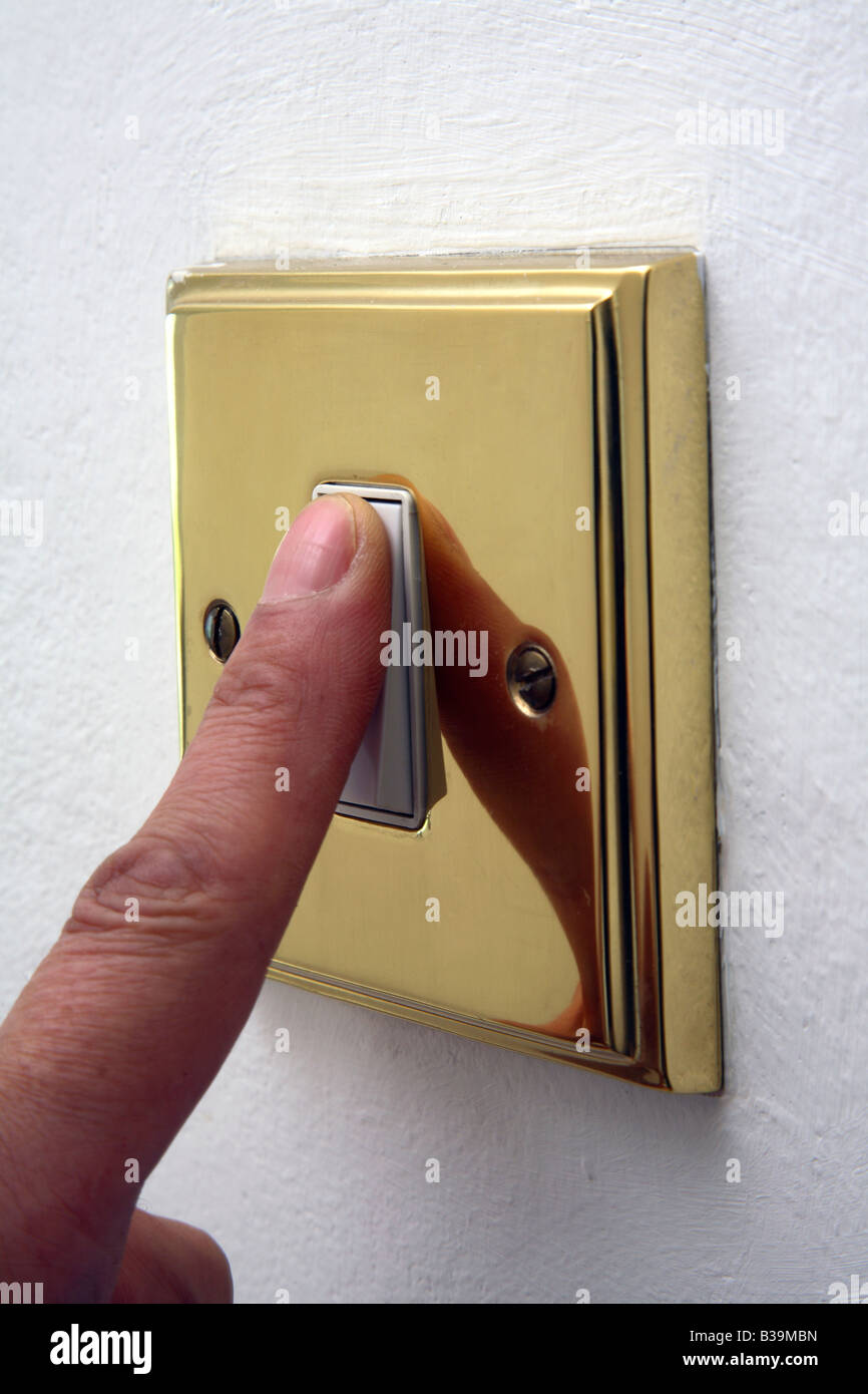 Finger turning off light switch Stock Photo Alamy