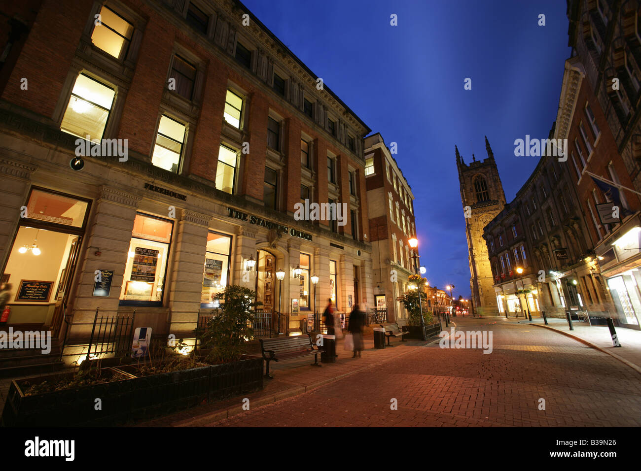 City of Derby, England. Night view Iron Gate properties and architecture, with Derby All Saints’ Cathedral in the background. Stock Photo