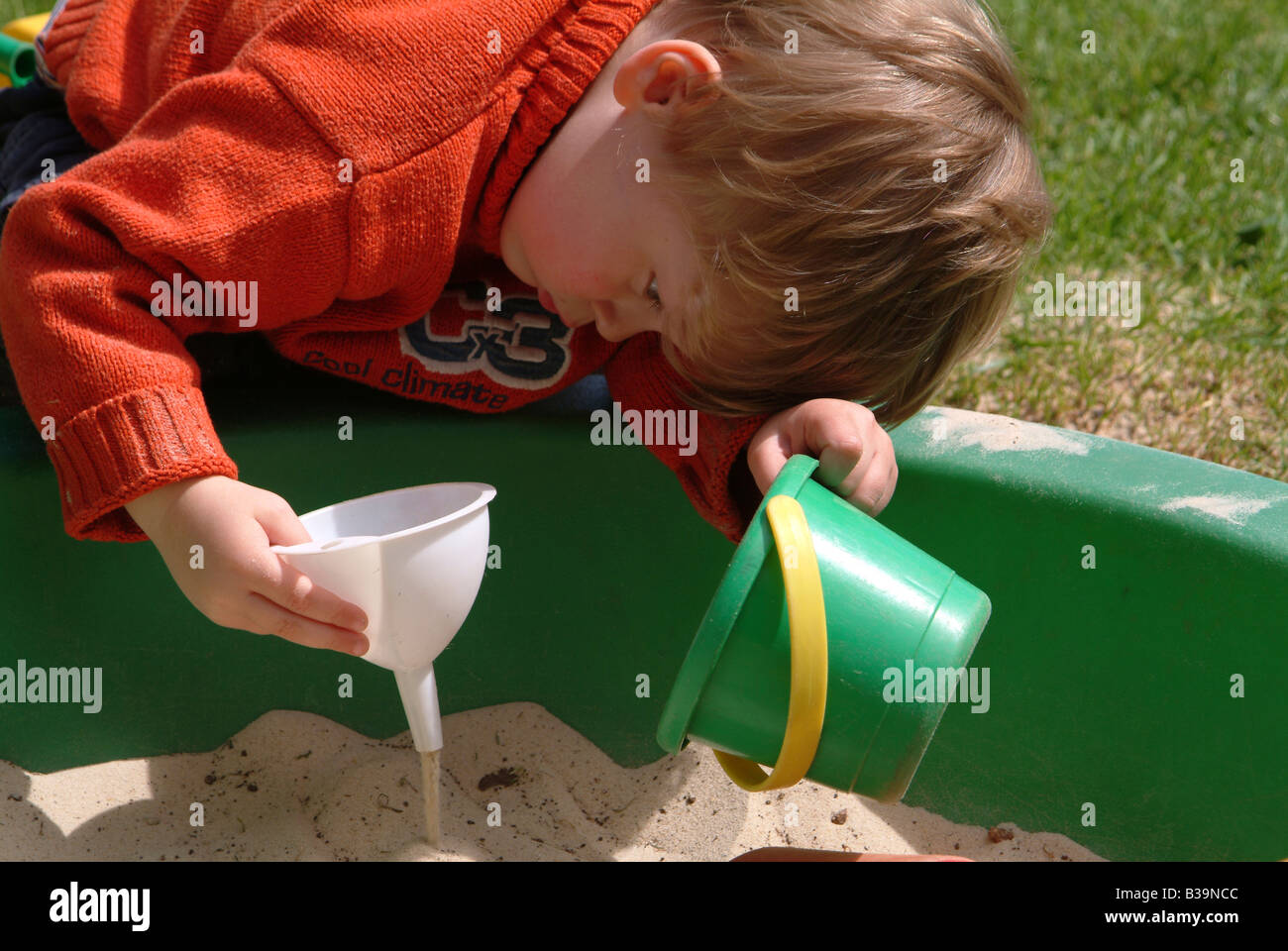 Child playing in a sandpit Stock Photo
