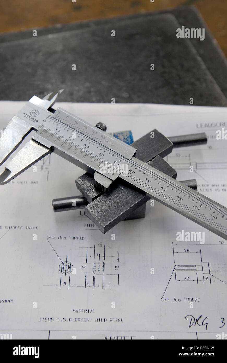 Precision measuring calipers with an engineering drawing Stock Photo