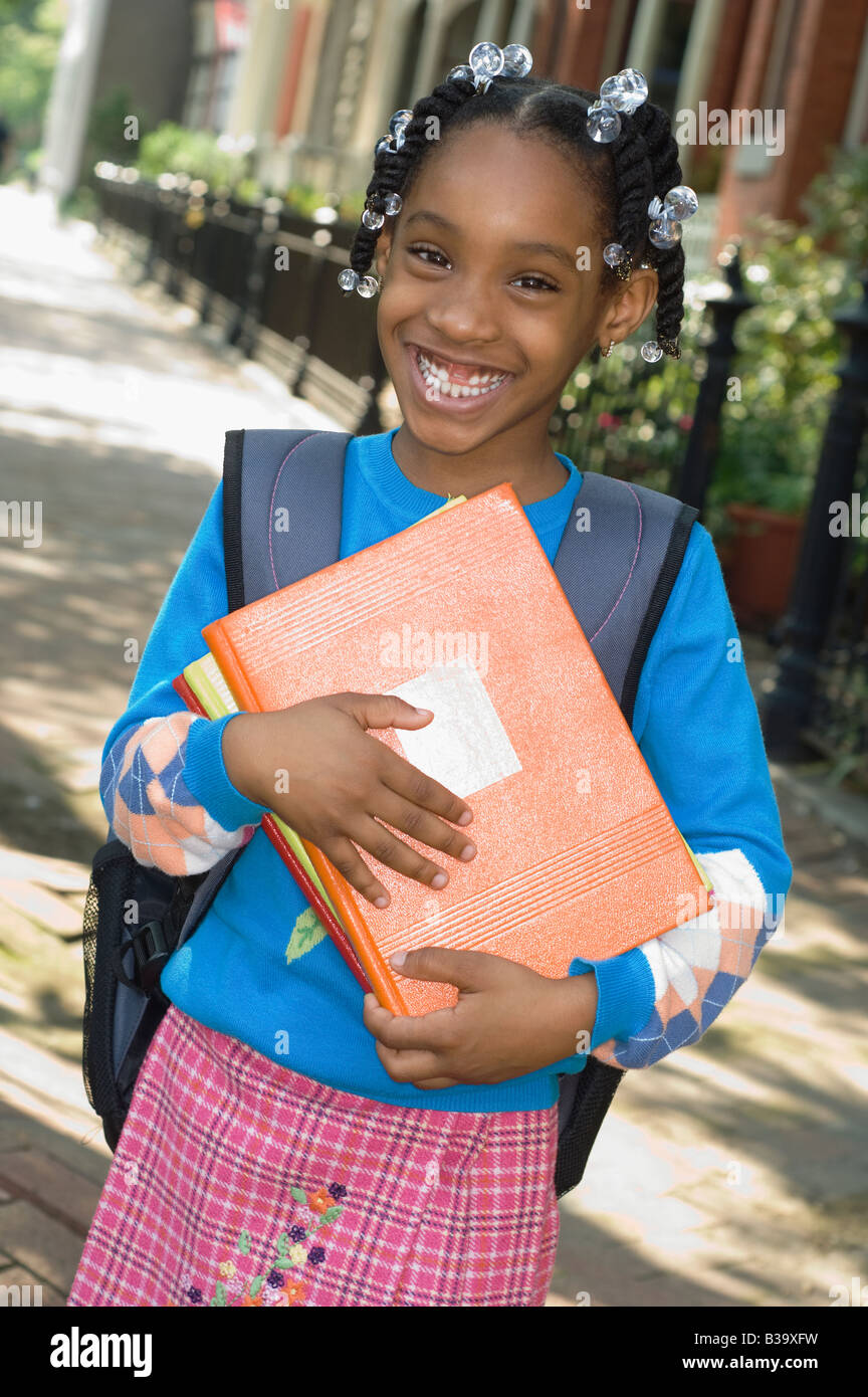 African girl holding school books Stock Photo - Alamy