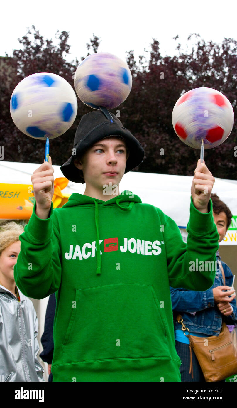 boy balancing spinning balls Stock Photo