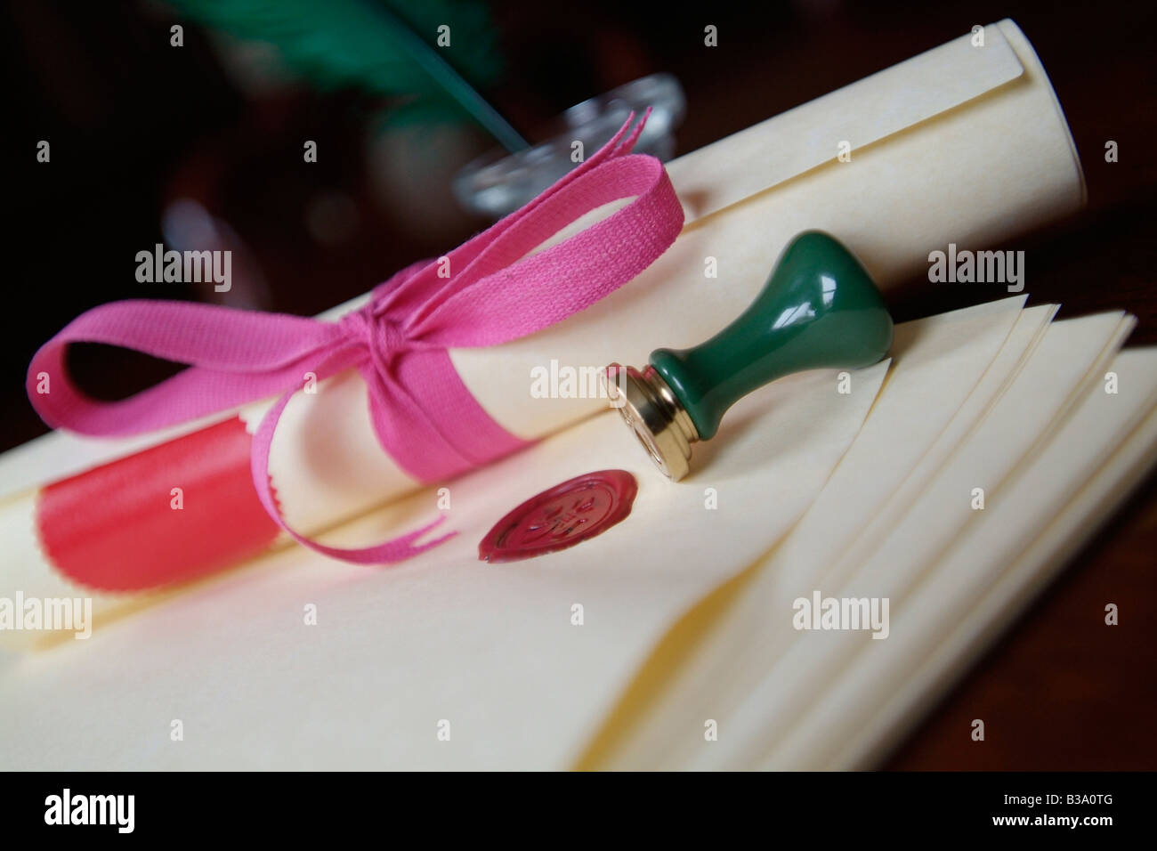 Scroll of legal documents bound in pink ribbon with wax seals and a