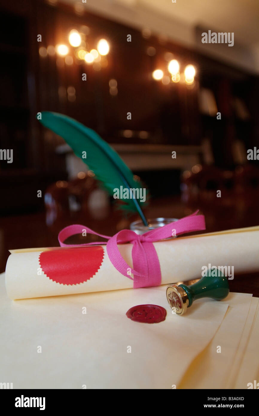 Scroll of legal documents bound in pink ribbon with wax seals and a quill pen Stock Photo Alamy