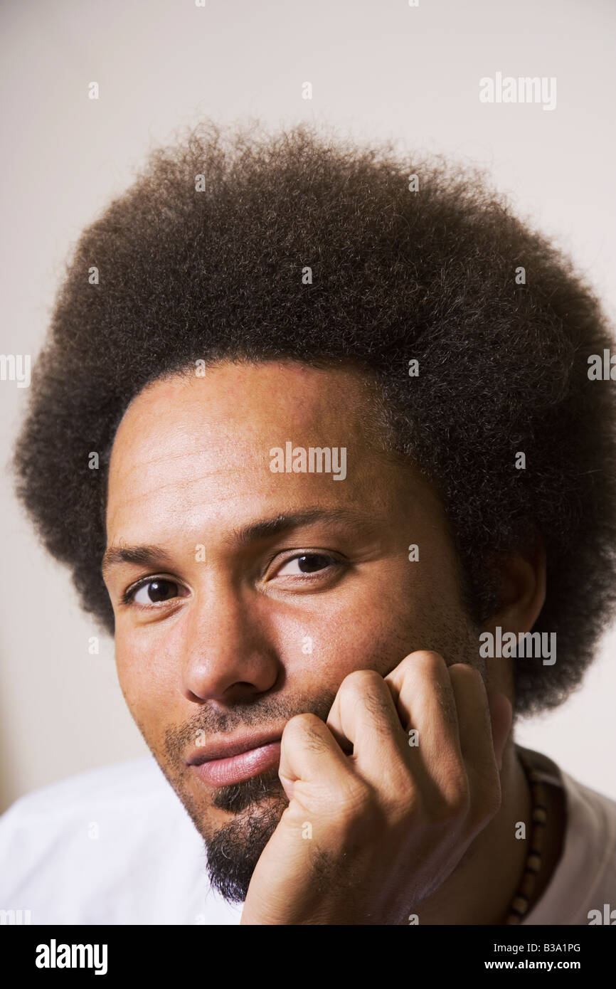 African man resting chin on hand Stock Photo - Alamy