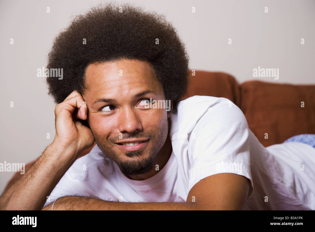 Smiling african man laying in hi-res stock photography and images - Alamy
