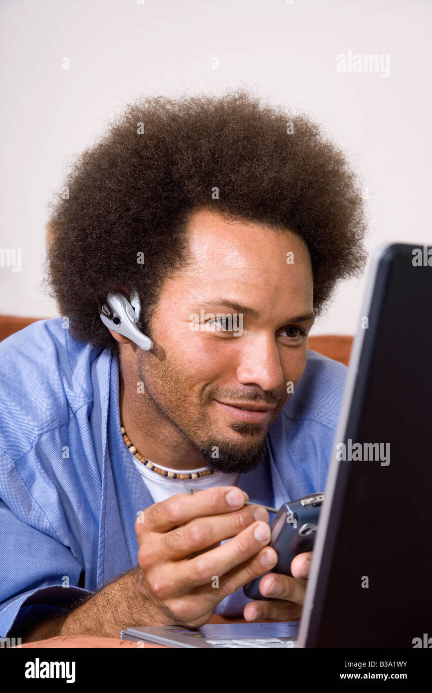 African man using electronic organizer Stock Photo