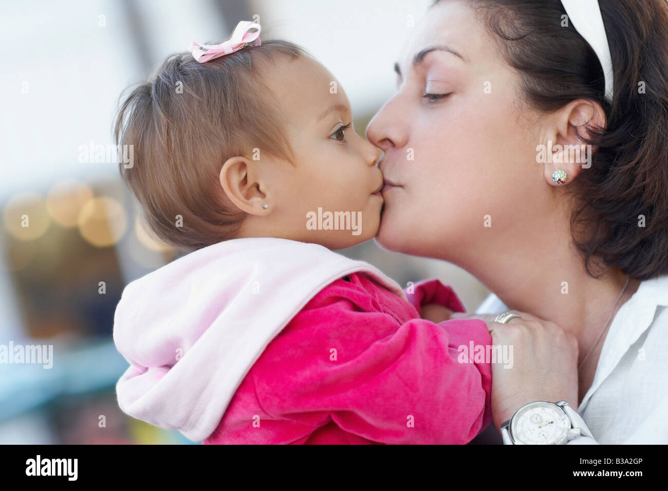 Mother kissing baby Stock Photo