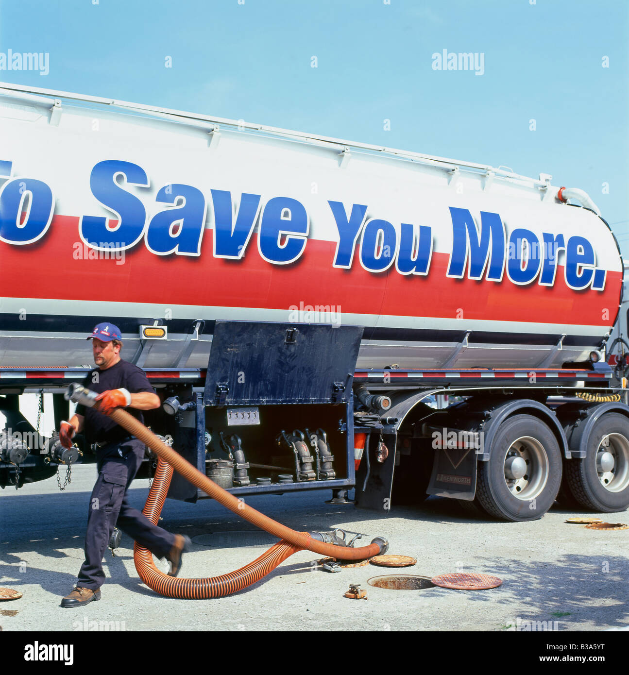 A fuel industry worker with a vapour removal pipe leading from a truck filling tanker at a Pioneer gas station in Ontario, Canada North America Stock Photo