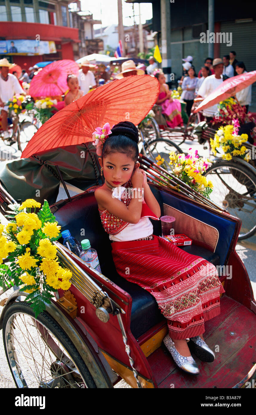 Thailand, Chiang Mai, Little Girl sitting in Trishaw at the Chiang Mai Flower Festival Parade Stock Photo