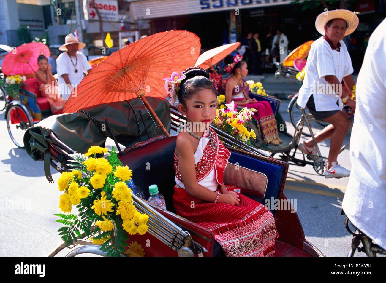 Thailand, Chiang Mai, Little Girl sitting in Trishaw at the Chiang Mai Flower Festival Parade Stock Photo