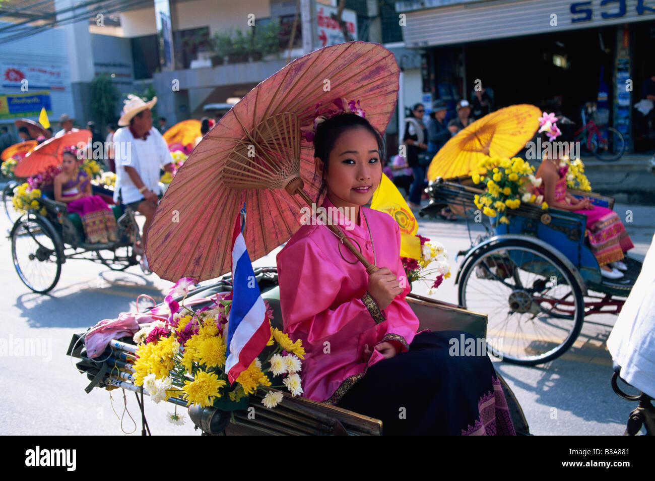 Thailand, Chiang Mai, Girl sitting in Trishaw at the Chiang Mai Flower Festival Parade Stock Photo