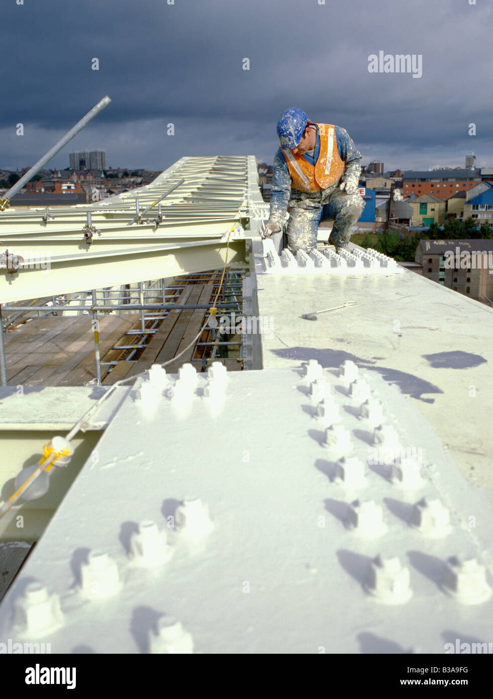 Man painting a bolted connection on a steel railway bridge, Newcastle