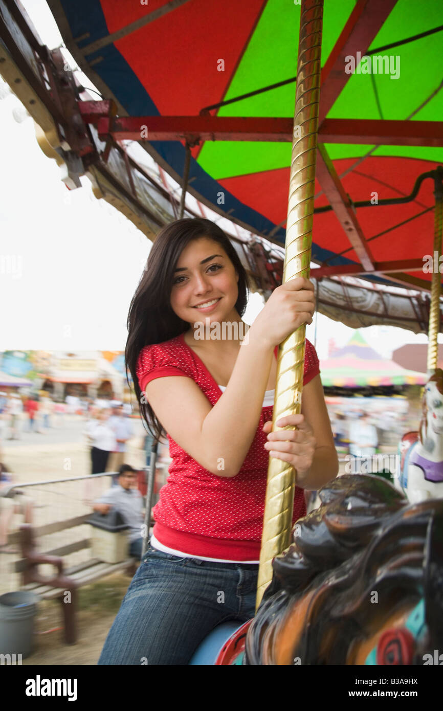 Mixed Race teenaged girl on carousel horse Stock Photo Alamy