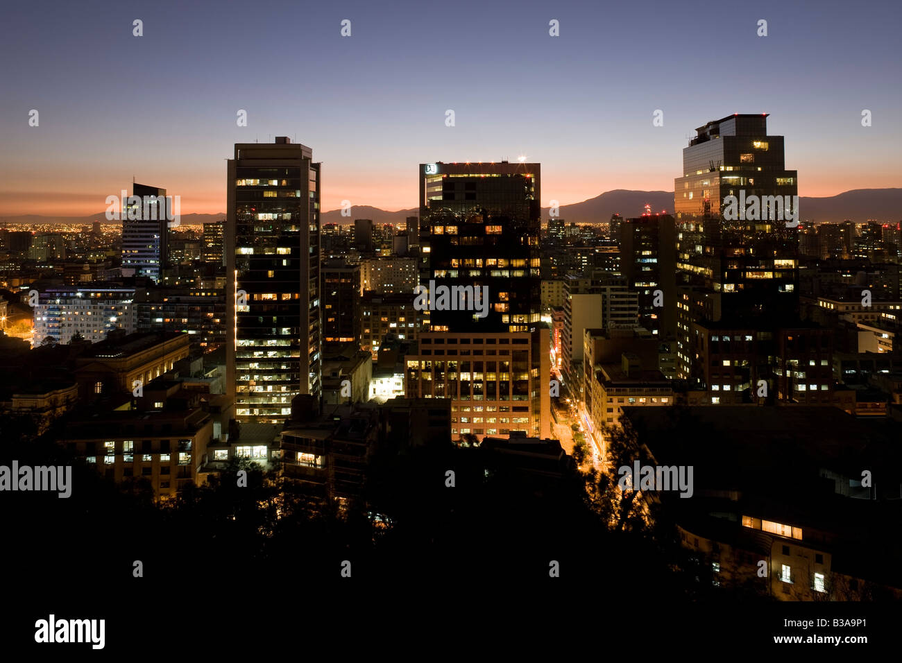 Chile, Santiago central business district city skyline and the Andes mountains at dusk Stock Photo