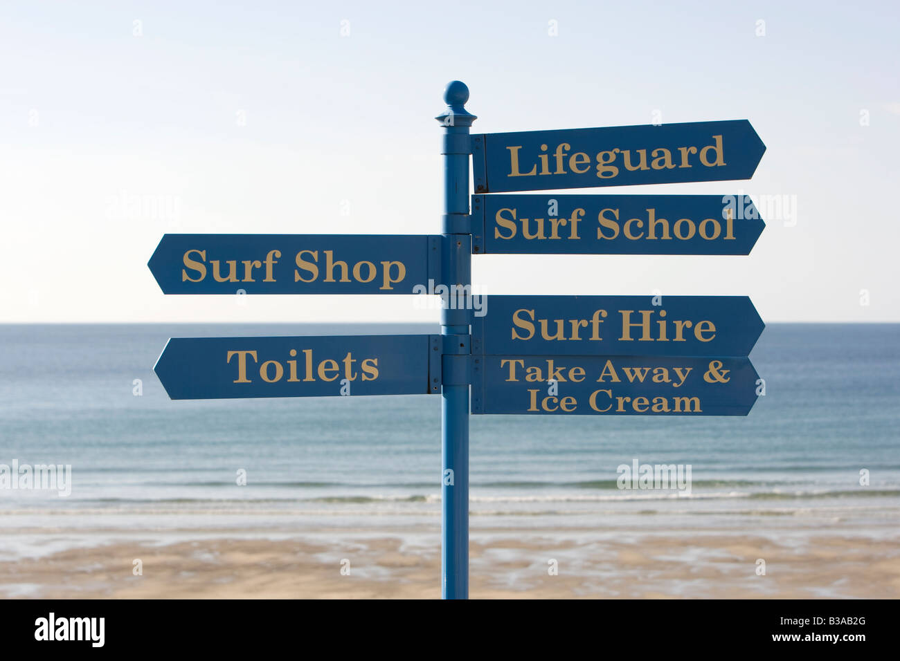 Sign on the beach at Sennen Cove points to various beach related services. Stock Photo