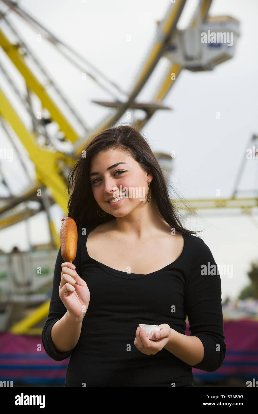Mixed Race girl holding corn dog Stock Photo - Alamy