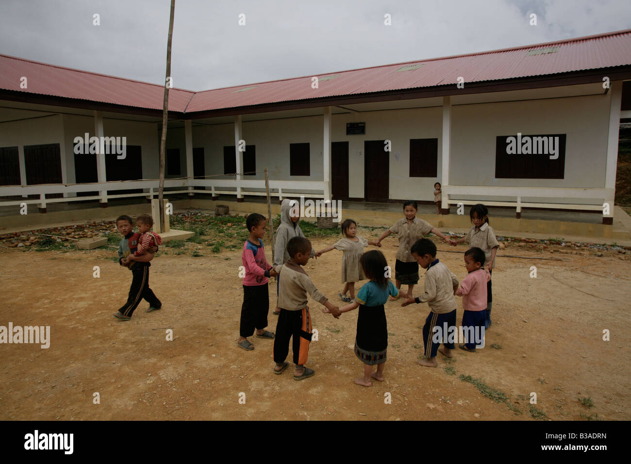 Nong Het district,Xieng Khouang province,Laos. Children play in playground  open after MAG cleared the site of UXO. Stock Photo
