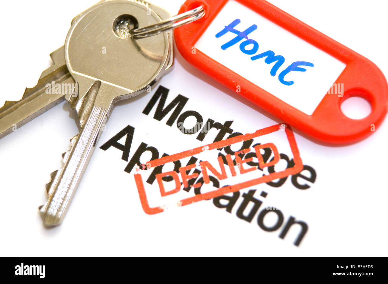 Home keys and mortgage application turned down Stock Photo