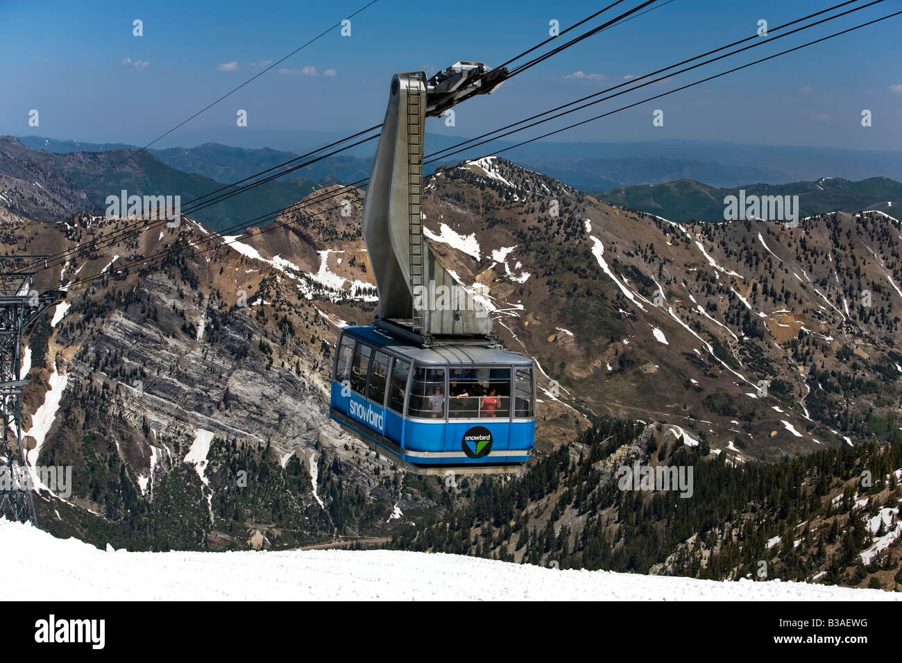 Snowbird tram on top of Wasatch Mountains. Summer snow melt at top Stock Photo