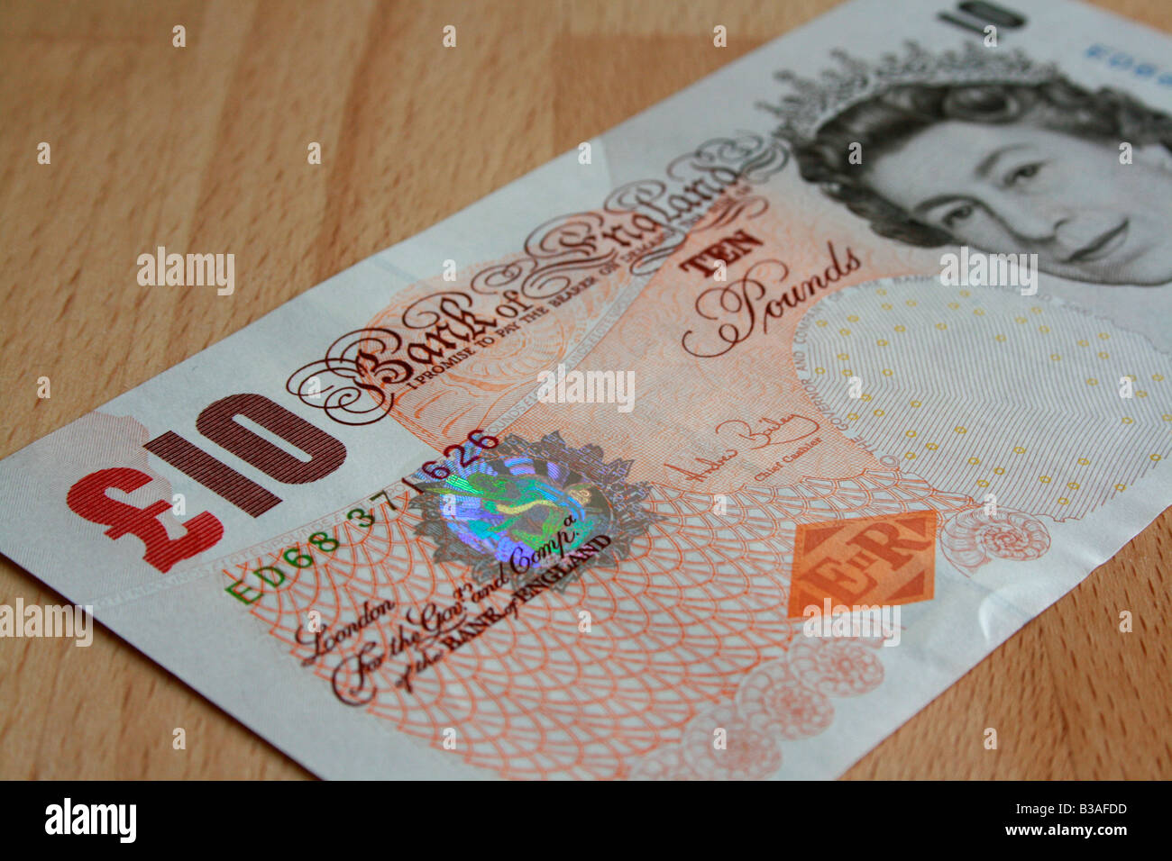 A £10 note laid out on a beech table Stock Photo - Alamy