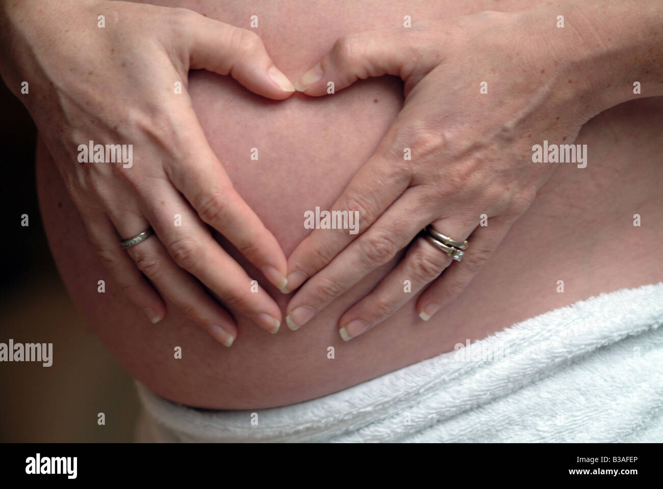 loveheart pregnant female detail stomach love woman beauty positive having children maternity pure sensitive caucasian young Stock Photo