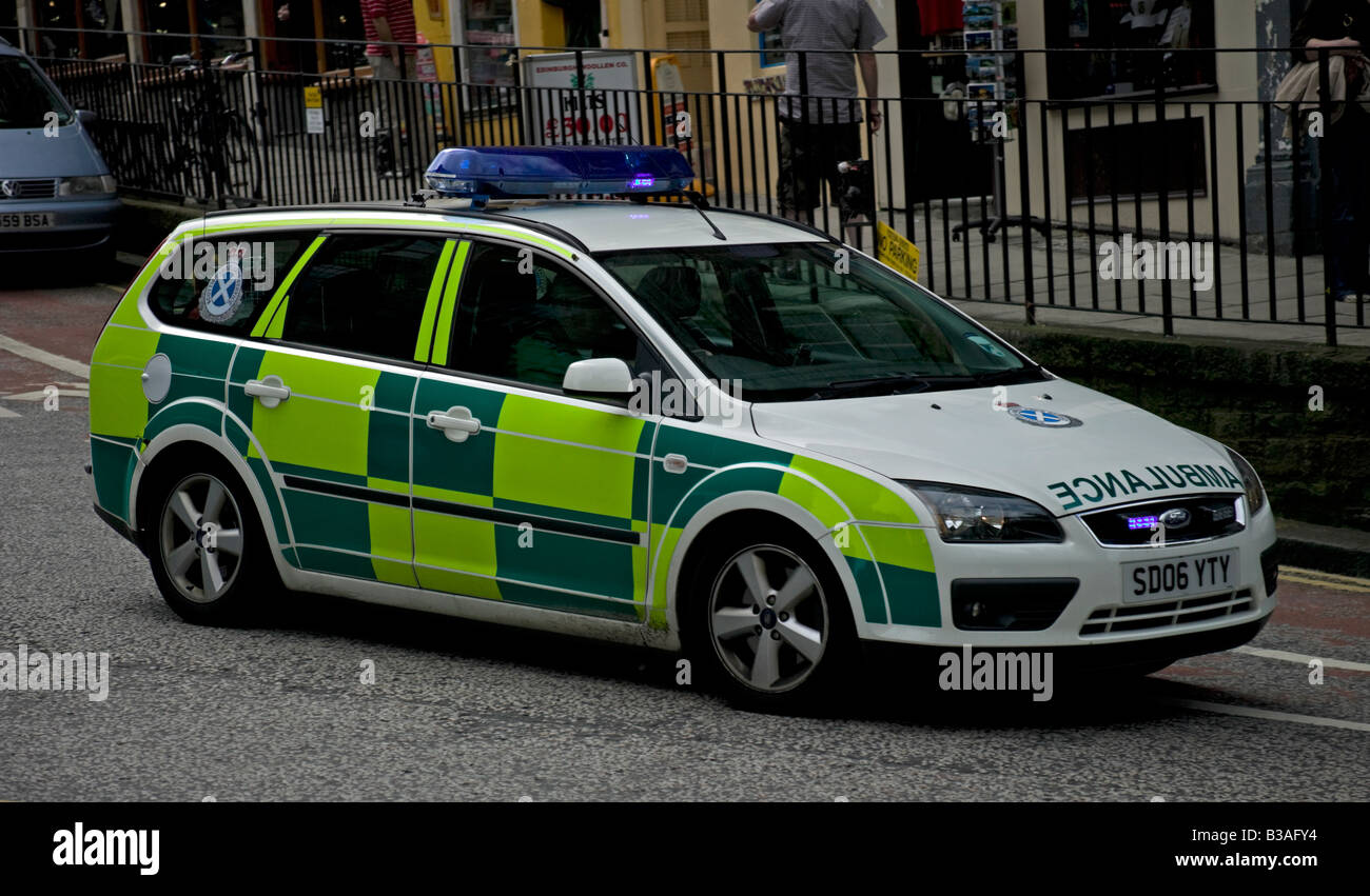 Ambulance vehicle with blue flashing lights proceeding to an emergency, Edinburgh, Scotland, UK, Europe Stock Photo