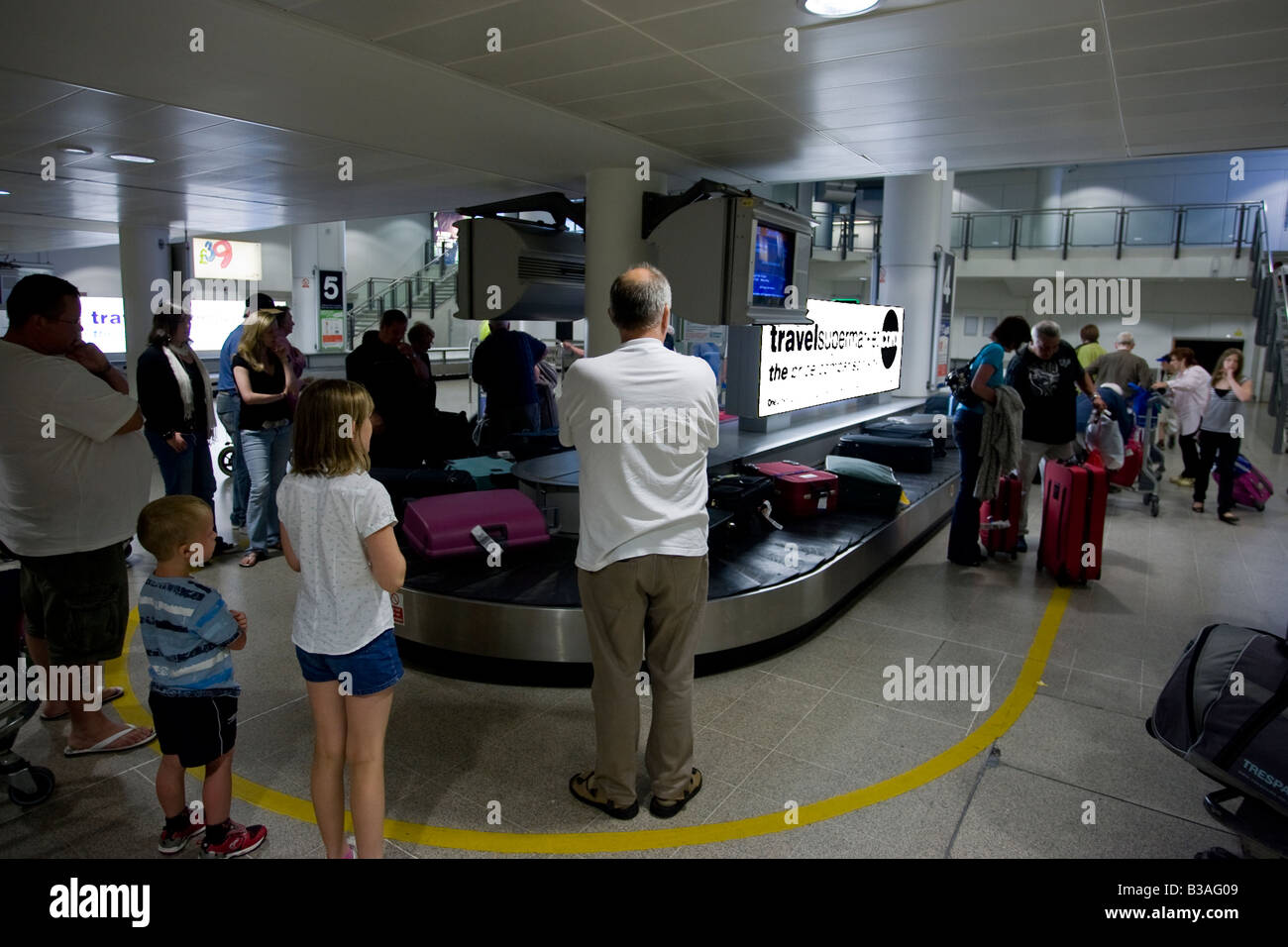 Waiting for luggage at luggage carousel Arrivals Manchester