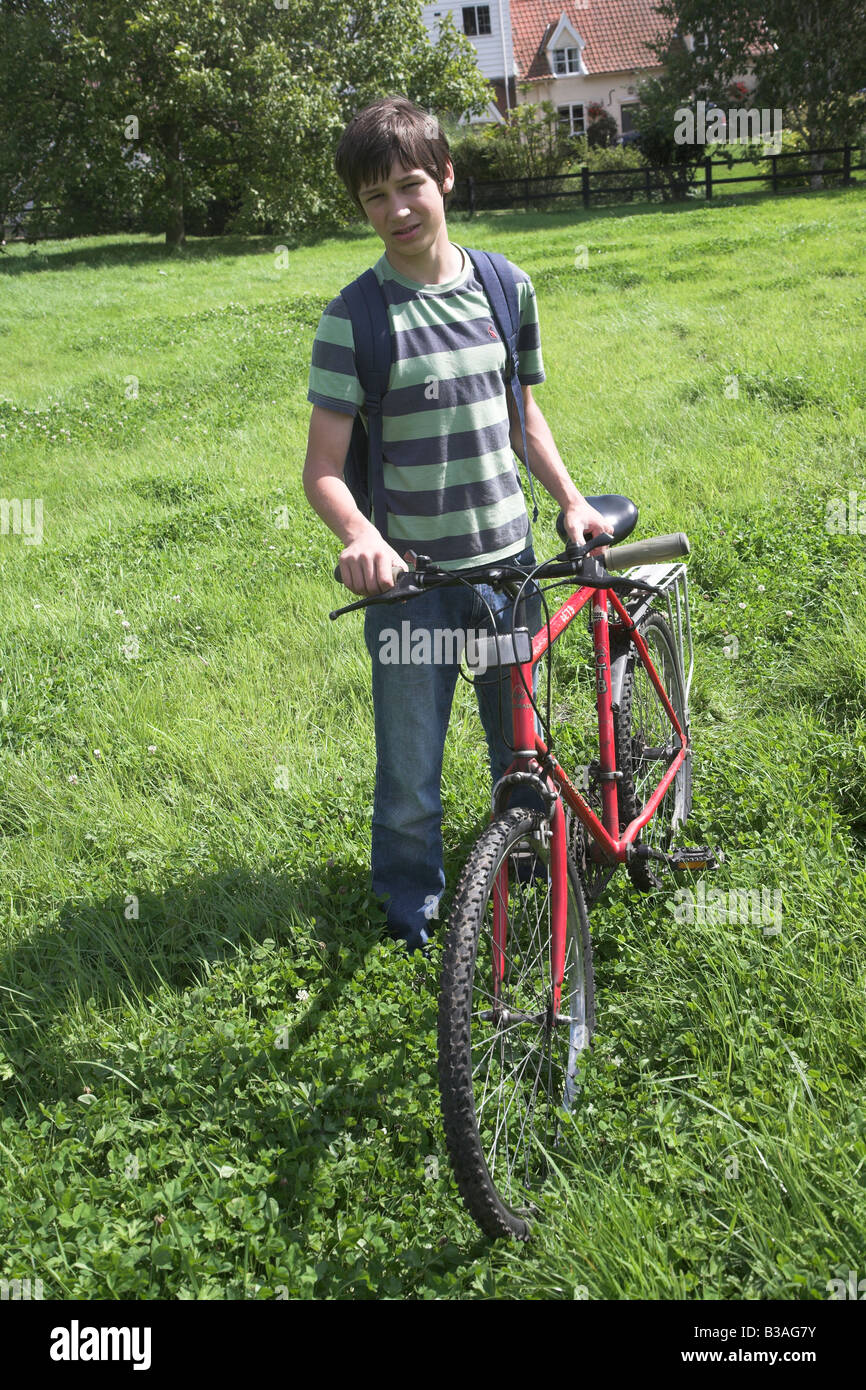 Teenage boy with his bike in the countryside Stock Photo Alamy