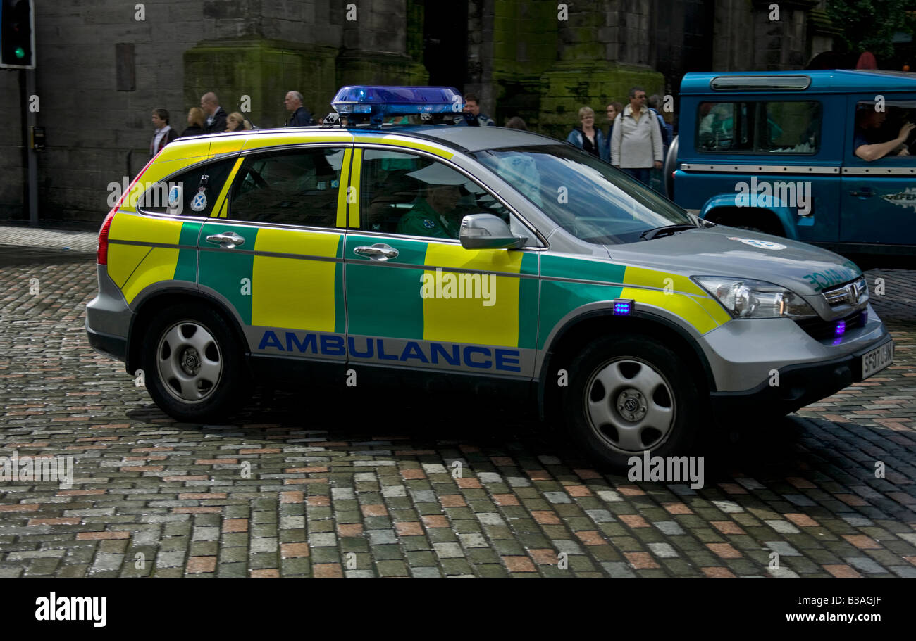 Ambulance vehicle passing through a traffic light junction,  South Bridge, Edinburgh, Scotland, UK, Europe Stock Photo