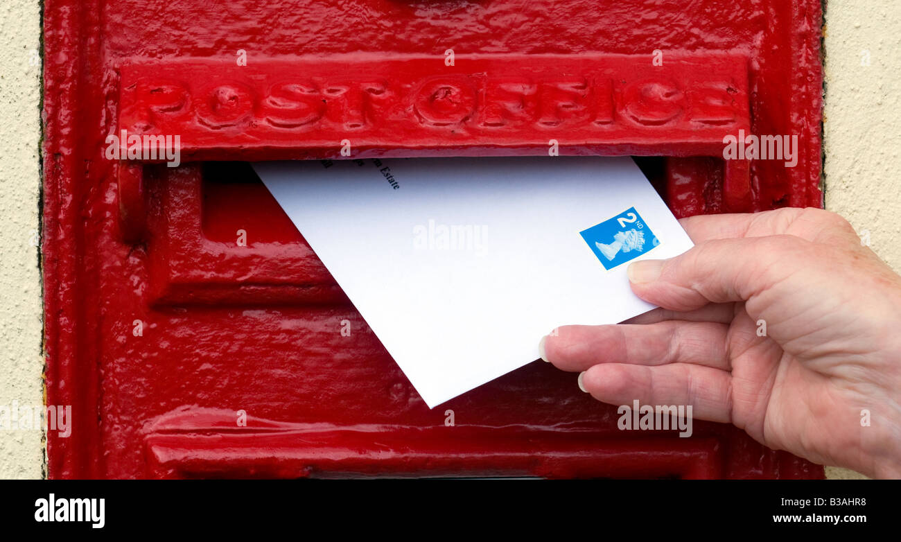 Posting 2nd class letter at letterbox UK Stock Photo Alamy