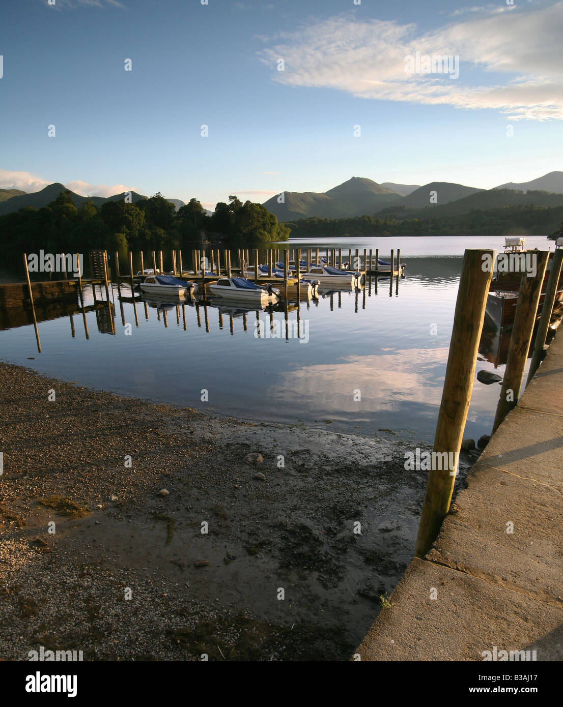 Landing stage posts boats clouds blue sky Lake District Stock Photo