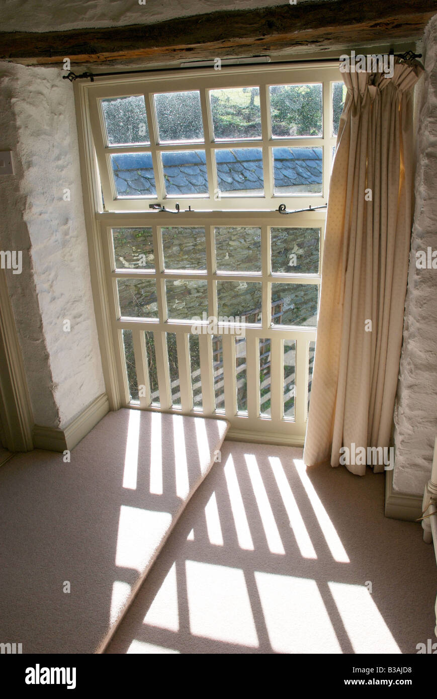 Sunlight shining through windowframe of rural property Stock Photo